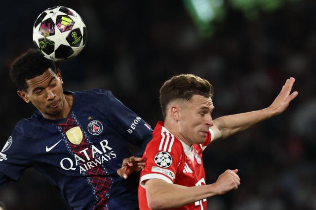 Paris Saint-Germain's French midfielder #24 Senny Mayulu goes for a header with Bayern Munich's German midfielder #06 Joshua Kimmich during the UEFA Champions League semi-final first leg football match between Paris Saint-Germain (PSG) and Bayern Munich at the Parc des Princes in Paris on April 28, 2026. (Photo by Anne-Christine POUJOULAT / AFP)
