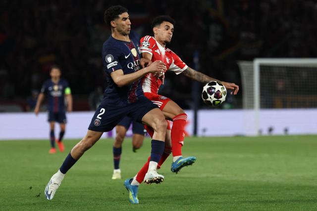 Paris Saint-Germain's Moroccan defender #02 Achraf Hakimi fights for the ball with Bayern Munich's Colombian forward #14 Luis Diaz during the UEFA Champions League semi-final first leg football match between Paris Saint-Germain (PSG) and Bayern Munich at the Parc des Princes in Paris on April 28, 2026. (Photo by Anne-Christine POUJOULAT / AFP)