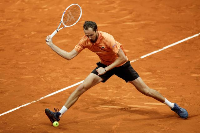 Russia's Daniil Medvedev returns the ball to Italy's Flavio Cobolli during their 2026 ATP Tour Madrid Open tennis tournament singles match at the Caja Magica in Madrid, on April 28, 2026. (Photo by OSCAR DEL POZO / AFP)