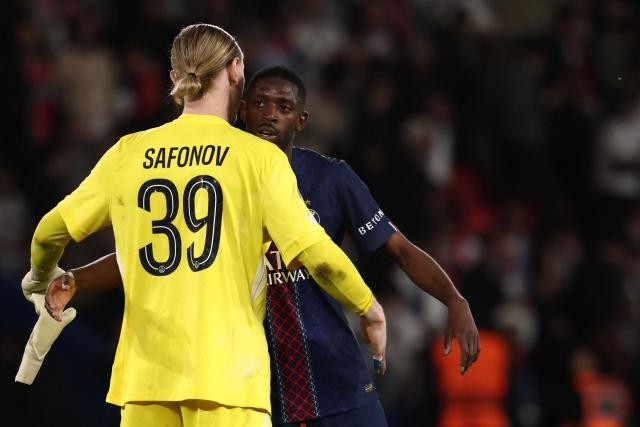 Paris Saint-Germain's Russian goalkeeper #39 Matvey Safonov hugs Paris Saint-Germain's French forward #10 Ousmane Dembele at the end of the UEFA Champions League semi-final first leg football match between Paris Saint-Germain (PSG) and Bayern Munich at the Parc des Princes in Paris on April 28, 2026. (Photo by FRANCK FIFE / AFP)