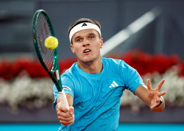 Czech Republic's Jakub Mensik returns the ball to Germany's Alexander Zverev during their 2026 ATP Tour Madrid Open tennis tournament singles match at the Caja Magica in Madrid, on April 28, 2026. (Photo by OSCAR DEL POZO / AFP)