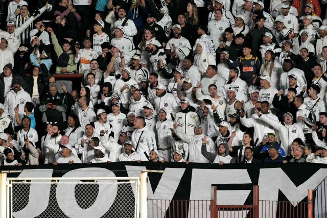 Santos fans cheer for their team before the Copa Sudamericana group stage football match between Argentina's San Lorenzo and Brazil's Santos at the Pedro Bidegain stadium in Buenos Aires on April 28, 2026. (Photo by JUAN MABROMATA / AFP)