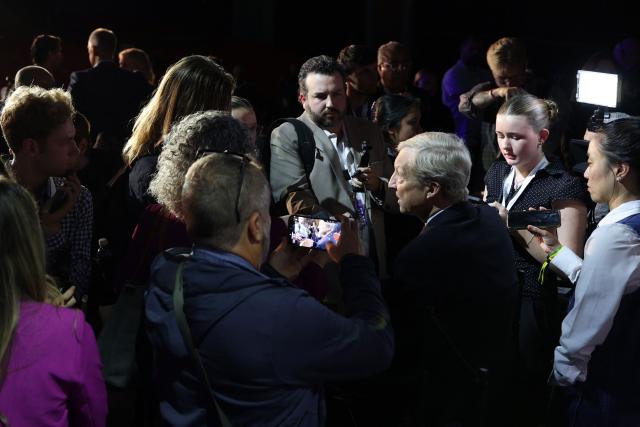 Democratic businessman and climate activist Tom Steyer (3rd-R) speaks to journalists after a California gubernatorial debate at Bridges Auditorium on the campus of Pomona College in Claremont, California, on April 28, 2026. The eight candidates for California governor are participating in the second televised debate, ahead of the June 2, 2026 primary elections. (Photo by Patrick T. Fallon / AFP)