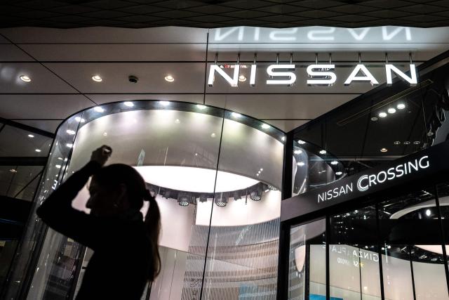 A pedestrian walks past the Japanese automaker Nissan's showroom in Tokyo's Ginza district on April 28, 2026. (Photo by Philip FONG / AFP)