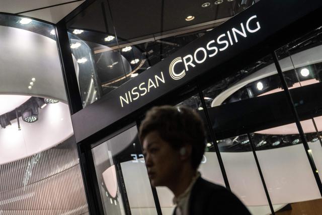 A pedestrian walks past the Japanese automaker Nissan's showroom in Tokyo's Ginza district on April 28, 2026. (Photo by Philip FONG / AFP)