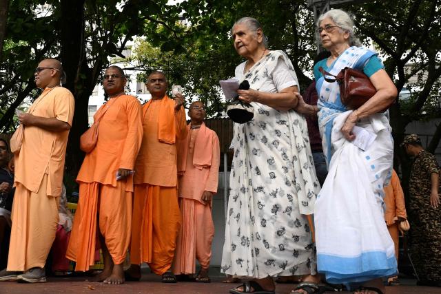 Members of International Society for Krishna Consciousness (ISKCON) stand in a queue to cast their votes during the second and final phase of the West Bengal Legislative Assembly elections at a polling station in Kolkata on April 29, 2026. (Photo by Dibyangshu SARKAR / AFP)
