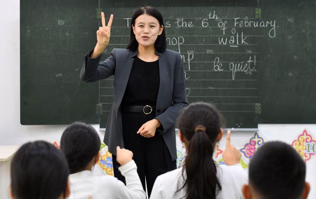 English teacher Kanykei Sovetova, 30, teaches pupils at a school in the northwestern village of Bukara, some 100 km from the Kyrgyz capital of Bishkek, on February 6, 2026. (Photo by Vyacheslav OSELEDKO / AFP)