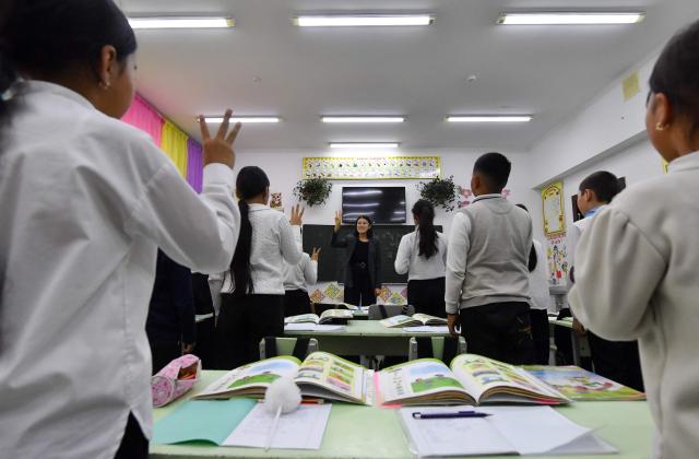 English teacher Kanykei Sovetova, 30, teaches pupils at a school in the northwestern village of Bukara, some 100 km from the Kyrgyz capital of Bishkek, on February 6, 2026. (Photo by Vyacheslav OSELEDKO / AFP)