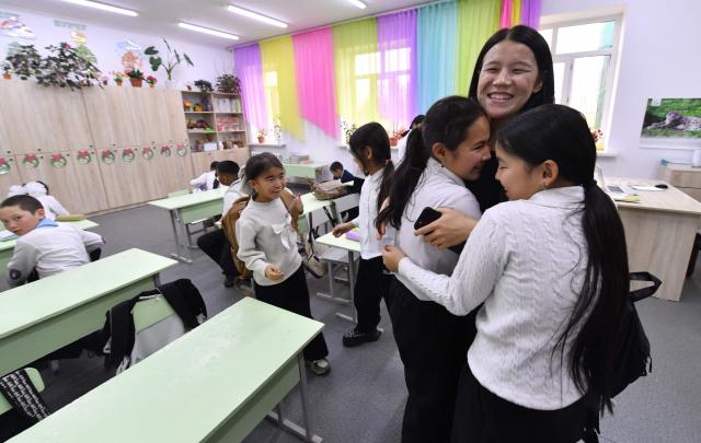English teacher Kanykei Sovetova, 30, teaches pupils at a school in the northwestern village of Bukara, some 100 km from the Kyrgyz capital of Bishkek, on February 6, 2026. (Photo by Vyacheslav OSELEDKO / AFP)
