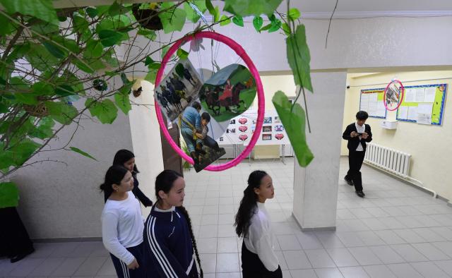 Pupils walk in a school's hallway in the northwestern village of Bukara, some 100 km from the Kyrgyz capital of Bishkek, on February 6, 2026. (Photo by Vyacheslav OSELEDKO / AFP)