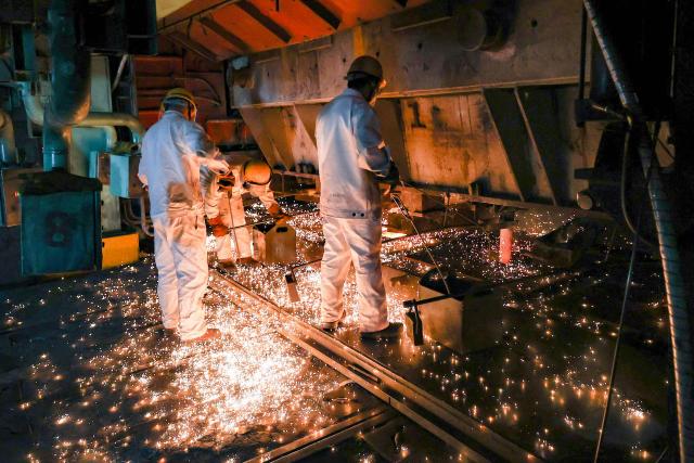 Workers are seen in a steel casting workshop in Lianyungang, in China’s eastern Jiangsu province on April 28, 2026. (Photo by CN-STR / AFP) / China OUT