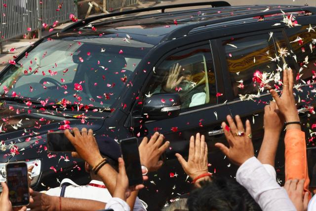 India's Prime Minister Narendra Modi waves to supporters as he arrives to seek blessings from Kashi Vishwanath Temple in Varanasi on April 29, 2026. (Photo by Niharika KULKARNI / AFP)