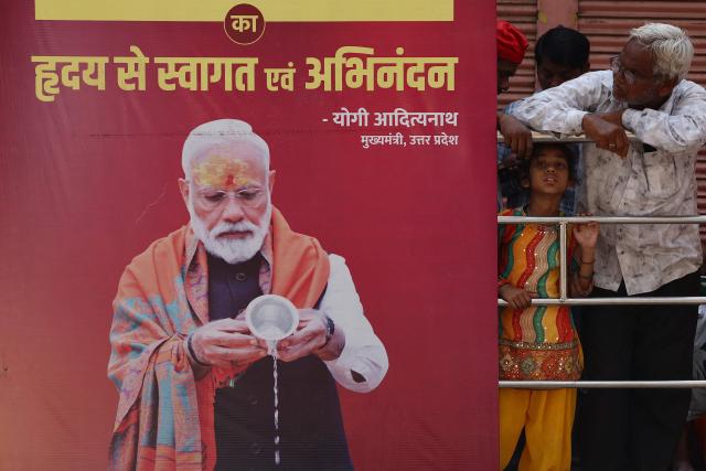 Supporters wait along a road during Indian Prime Minister Narendra Modi's visit in Varanasi on April 29, 2026. (Photo by Niharika KULKARNI / AFP)