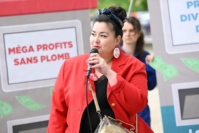 ATTAC's spokesperson Youlie Yamamoto speaks during a staged protest action called by 350.org, Action Justice Climat, Attac France, Greenpeace France and Extinction Rebellion France against French company TotalEnergies marking the publication of its first-quarter results in Paris on April 29, 2026. French oil and gas giant TotalEnergies reported on April 29, 2026, a first-quarter net profit of $5.8 billion, up by nearly 50% year-on-year, driven by rising oil prices linked to the war in the Middle East. (Photo by Martin LELIEVRE / AFP)