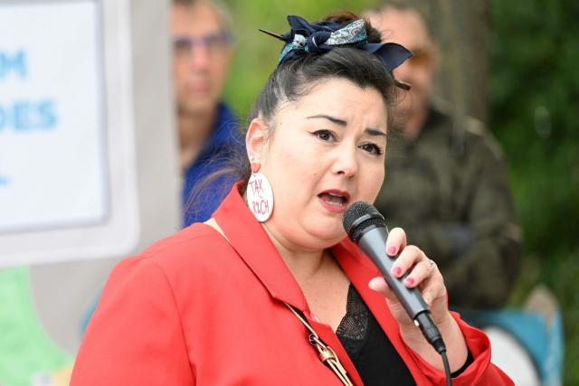 ATTAC's spokesperson Youlie Yamamoto speaks during a staged protest action called by 350.org, Action Justice Climat, Attac France, Greenpeace France and Extinction Rebellion France against French company TotalEnergies marking the publication of its first-quarter results in Paris on April 29, 2026. French oil and gas giant TotalEnergies reported on April 29, 2026, a first-quarter net profit of $5.8 billion, up by nearly 50% year-on-year, driven by rising oil prices linked to the war in the Middle East. (Photo by Martin LELIEVRE / AFP)