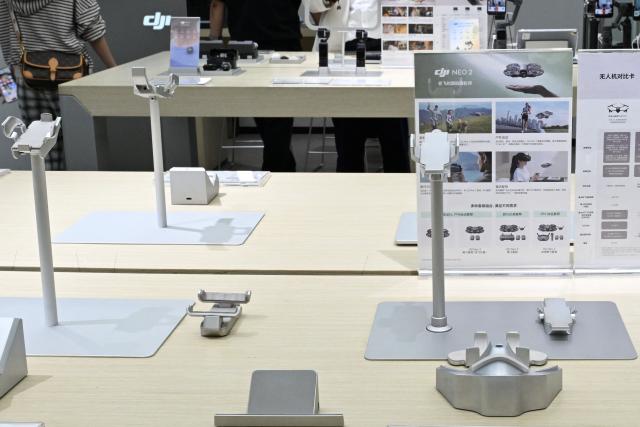 Empty display stands for drones are seen at a DJI store at a mall in Beijing on April 29, 2026, ahead a ban against the sale of consumer drones by the city government which begins on May 1. (Photo by Adek BERRY / AFP)