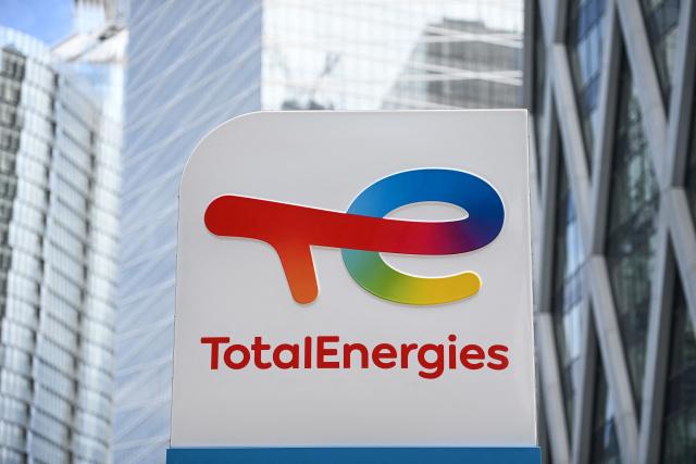 (FILES) This photograph shows the new TotalEnergies logo during its unveling ceremony, at a charging station in La Defense on the outskirts of Paris on May 28, 2021. TotalEnergies announced on April 29, 2026, the reopening of the SATORP refinery, a joint venture owned by TotalEnergies and the Saudi state-owned Aramco group in Saudi Arabia, which was closed after attacks. (Photo by Christophe ARCHAMBAULT / AFP)