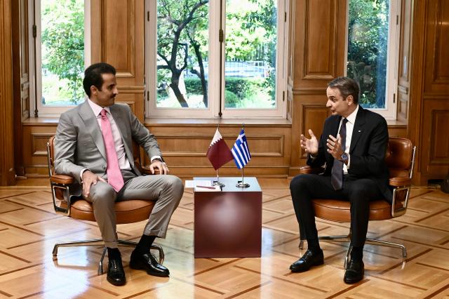 Greece's Prime Minister Kyriakos Mitsotakis (R) speaks with the Emir of Qatar Tamim bin Hamad Al Thani during their meeting in Athens on April 29, 2026. (Photo by Aris MESSINIS / AFP)