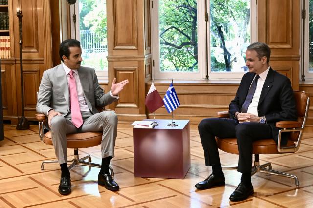 Greece's Prime Minister Kyriakos Mitsotakis (R) speaks with the Emir of Qatar Tamim bin Hamad Al Thani during their meeting in Athens on April 29, 2026. (Photo by Aris MESSINIS / AFP)