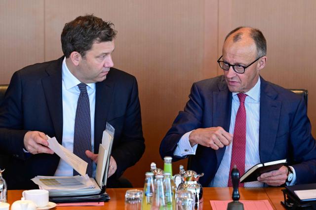 German Finance Minister and Vice Chancellor Lars Klingbeil (L) and Germany's Chancellor Friedrich Merz get ready for the weekly cabinet meeting at the Chancellery in Berlin on April 29, 2026. (Photo by John MACDOUGALL / AFP)