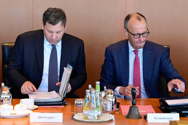 German Finance Minister and Vice Chancellor Lars Klingbeil (L) and Germany's Chancellor Friedrich Merz get ready for the weekly cabinet meeting at the Chancellery in Berlin on April 29, 2026. (Photo by John MACDOUGALL / AFP)