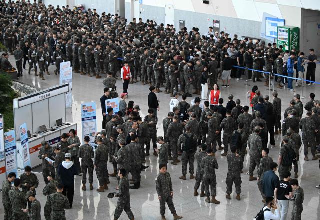South Korean soldiers wait in line to attend the annual job fair for soldiers scheduled for discharge, hosted by the South Korean Defence Ministry, at KINTEX exhibition hall in Goyang on April 29, 2026. (Photo by Jung Yeon-je / AFP)