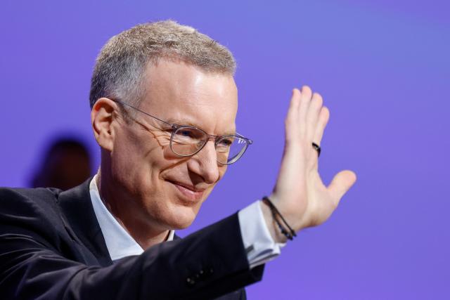 Chief Executive Officer (CEO) of Munich Re Group, Christoph Jurecka waves as he arrives to attend the Annual General Meeting (AGM) of the reinsurer at the headquarters in Munich, southern Germany, on April 29, 2026. (Photo by Michaela STACHE / AFP)