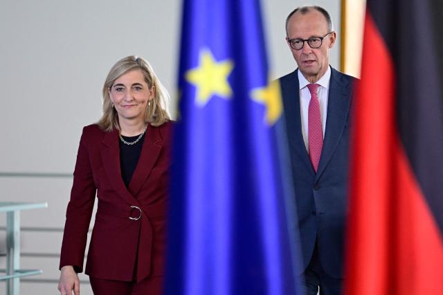 German Chancellor Friedrich Merz and German Health Minister Nina Warken arrive to give a press statement at the Chancellery in Berlin on April 29, 2026. (Photo by John MACDOUGALL / AFP)