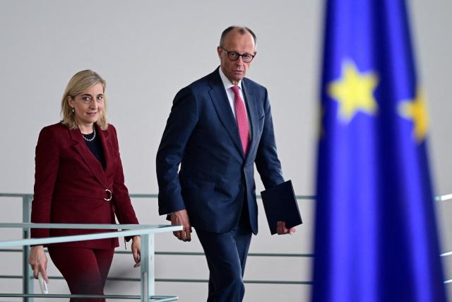 German Chancellor Friedrich Merz and German Health Minister Nina Warken arrive to give a press statement at the Chancellery in Berlin on April 29, 2026. (Photo by John MACDOUGALL / AFP)