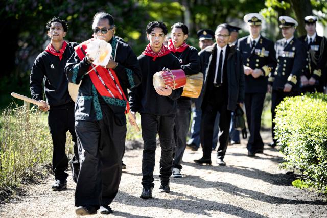 Attendees playing the tifa drum take part in a procession to inaugurate the new monument in recognition of the efforts of Moluccan marines in 1946, in Amsterdam on April 29, 2026, marking the 75th anniversary of the Moluccans' presence in the Netherlands. In 1946, the first Moluccan men came to the Netherlands for training with the Royal Netherlands Navy, after which they served in active service in Amsterdam, as well as in Indonesia and other parts of the Kingdom. (Photo by Ramon van Flymen / ANP / AFP) / Netherlands OUT