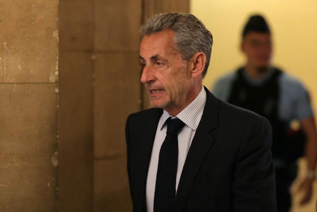 France's former President Nicolas Sarkozy arrives to the courtroom after a break during his final hearing in his appeal trial over charges he had sought Libyan financing for his 2007 election in exchange for helping improve Tripoli's image after deadly bombing, at the Palais de Justice courthouse in Paris on April 29, 2026. (Photo by Thomas SAMSON / AFP)