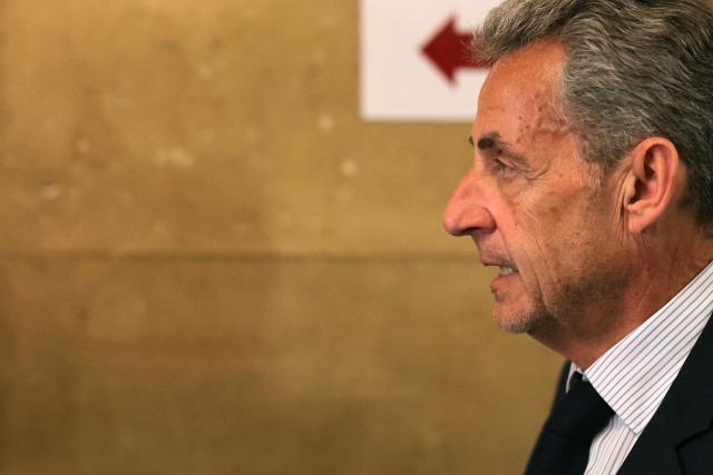 France's former President Nicolas Sarkozy arrives to the courtroom after a break during his final hearing in his appeal trial over charges he had sought Libyan financing for his 2007 election in exchange for helping improve Tripoli's image after deadly bombing, at the Palais de Justice courthouse in Paris on April 29, 2026. (Photo by Thomas SAMSON / AFP)