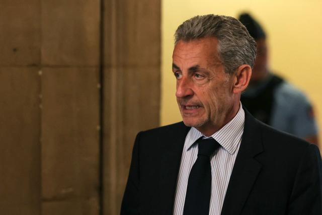 France's former President Nicolas Sarkozy arrives to the courtroom after a break during his final hearing in his appeal trial over charges he had sought Libyan financing for his 2007 election in exchange for helping improve Tripoli's image after deadly bombing, at the Palais de Justice courthouse in Paris on April 29, 2026. (Photo by Thomas SAMSON / AFP)