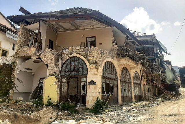 This photograph shows a general view of a heavily damaged hotel in Antakya's partly remaining old town on April 1, 2026, over three years after the earthquake that devastated southeastern Turkey, including Antakya, on February 6, 2023. Nothing is "as it was before" the earthquake that devastated the ancient city and southern Turkey in February 2023, killing at least 53,000 people : Three years after the disaster, residents are denouncing opaque reconstruction plans that threaten to empty the old town and jeopardise its multicultural identity. Once bustling, adjacent to working-class neighbourhoods as well as Muslim, Christian and Jewish places of worship, Kurtulus Avenue is now a vast construction site where listed historic buildings are being hastily rebuilt, with support from the European Union. The old town of Antakya was home to more than 13,000 residents before the earthquake, but virtually no homes will remain, according to the controversial new urban development plan. (Photo by Burcin GERCEK / AFP) / TO GO WITH AFP STORY BY BURC?N GERCEK