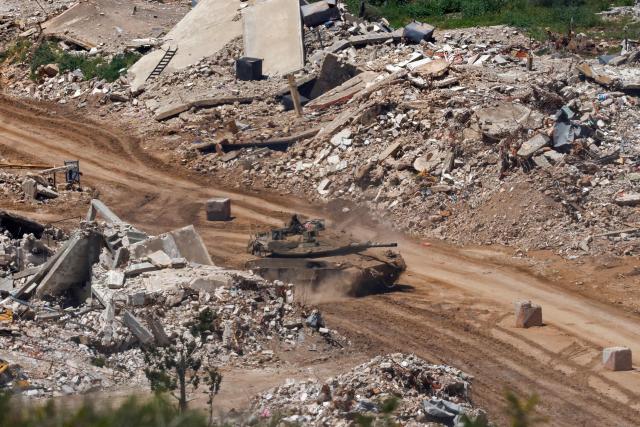 This photograph taken from the northern Israel shows an Israeli tank driving along the road between destroyed houses in southern Lebanon near the border with Israel, on April 29, 2026. Lebanon's army said on April 29 that one of its soldiers was among two people killed in an Israeli strike in the country's south, the latest deadly raid despite a ceasefire in the Israel-Hezbollah war. (Photo by Jalaa MAREY / AFP)