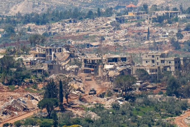 This photograph taken from the northern Israel shows Israeli tanks driving along the road between destroyed houses in southern Lebanon near the border with Israel, on April 29, 2026. Lebanon's army said on April 29 that one of its soldiers was among two people killed in an Israeli strike in the country's south, the latest deadly raid despite a ceasefire in the Israel-Hezbollah war. (Photo by Jalaa MAREY / AFP)