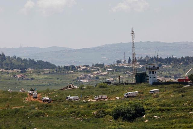 This photograph taken from the northern Israel shows a United Nations (UN) convoy driving close to destroyed houses in southern Lebanon near the border with Israel, on April 29, 2026. Lebanon's army said on April 29 that one of its soldiers was among two people killed in an Israeli strike in the country's south, the latest deadly raid despite a ceasefire in the Israel-Hezbollah war. (Photo by Jalaa MAREY / AFP)
