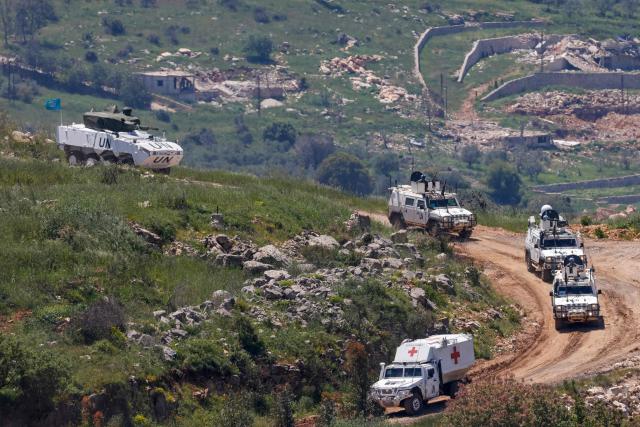 This photograph taken from the northern Israel shows a United Nations (UN) convoy driving through southern Lebanon near the border with Israel, on April 29, 2026. Lebanon's army said on April 29 that one of its soldiers was among two people killed in an Israeli strike in the country's south, the latest deadly raid despite a ceasefire in the Israel-Hezbollah war. (Photo by Jalaa MAREY / AFP)