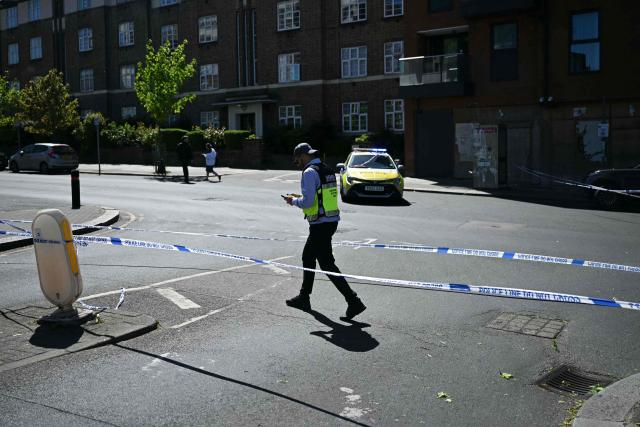 A member of the local security patrol walks past a cordon in the Golders Green neighbourhood of north London on April 29, 2026, following the stabbing to two people nearby. Two people were stabbed on April 29 in north London, Jewish groups said, following a series of arson attacks targeting Jewish sites in the area. A man was arrested after he was seen running with a knife "attempting to stab Jewish members of the public", the Shomrim Jewish neighbourhood watch said on social media. (Photo by JUSTIN TALLIS / AFP)