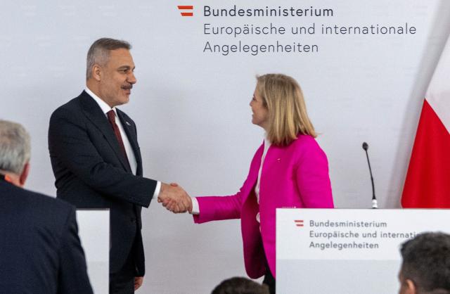 Austrian Foreign Minister Beate Meinl-Reisinger shakes hands with her Turkish counterpart, Foreign Minister Hakan Fidan after they addressed a joint press conference in Vienna on April 29, 2026. (Photo by Joe Klamar / AFP)