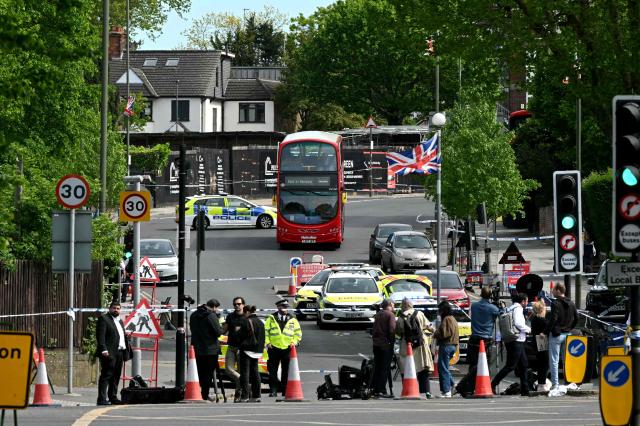 Members of the media work at a Police cordon on Golders Green Road, in the Golders Green neighbourhood of north London, on April 29, 2026, after two people were stabbed, and a suspect arrested. Two people were stabbed on April 29 in north London, Jewish groups said, following a series of arson attacks targeting Jewish sites in the area. A man was arrested after he was seen running with a knife "attempting to stab Jewish members of the public", the Shomrim Jewish neighbourhood watch said on social media. (Photo by JUSTIN TALLIS / AFP)