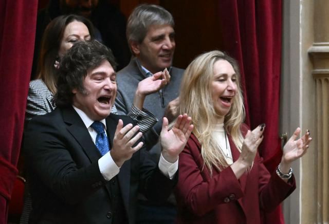 Argentina's President Javier Milei and his sister Secretary General of the Presidency  Karina Milei cheer for his Chief of Cabinet Manuel Adorni's as he prepares to present his management report to the Argentina's congress in Buenos Aires on April 29, 2026. Adorni presents his management report to the Argentina's congress, accompanied by President Javier Milei—a forceful show of support amidst questions regarding his personal assets. (Photo by Luis ROBAYO / AFP)