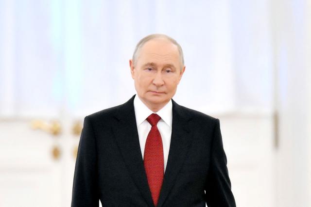 In this pool photograph distributed by the Russian state agency Sputnik, Russia's President Vladimir Putin arrives to welcome Congo-Brazzaville's president in Moscow on April 29, 2026. (Photo by Grigory SYSOYEV / POOL / AFP)