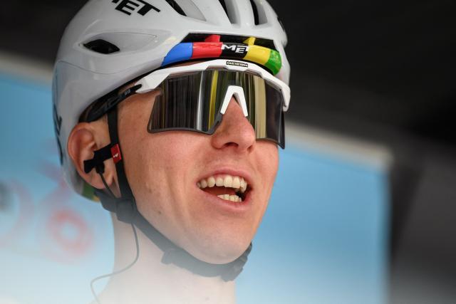 UAE Team Emirates-XRG's Slovenian rider Tadej Pogacar reacts during the teams' presentation prior to the first stage of the Tour of Romandie UCI cycling World tour, a 171.2 km loop from Martigny-Ville to Martigny-Ville, in Martigny on April 29, 2026. (Photo by Fabrice COFFRINI / AFP)