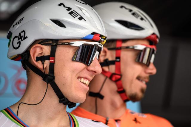 UAE Team Emirates-XRG's Slovenian rider Tadej Pogacar (L) looks on next to his teammate Portuguese rider Ivo Oliveira during the teams' presentation prior to the first stage of the Tour of Romandie UCI cycling World tour, a 171.2 km loop from Martigny-Ville to Martigny-Ville, in Martigny on April 29, 2026. (Photo by Fabrice COFFRINI / AFP)