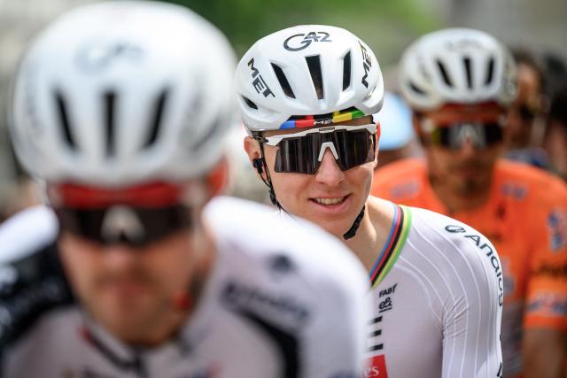 UAE Team Emirates-XRG's Slovenian rider Tadej Pogacar (C) arrives for the teams' presentation prior to the first stage of the Tour of Romandie UCI cycling World tour, a 171.2 km loop from Martigny-Ville to Martigny-Ville, in Martigny on April 29, 2026. (Photo by Fabrice COFFRINI / AFP)