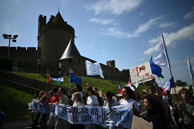 Protesters demonstrate in front of the medieval citadel at the call of "Nous Carcassonne" collective against the decisions taken by Carcassonne's 'Rassemblement National' newly elected mayor, in Carcassonne, southwestern France on April 29, 2026. (Photo by LIONEL BONAVENTURE / AFP)