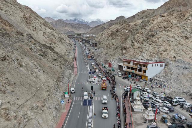 An aerial view shows a religious procession upon the arrival of sacred relics linked to the Buddha in Leh on April 29, 2026. (Photo by Mohd Arhaan ARCHER / AFP)