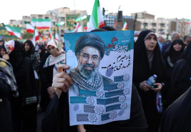 An Iranian holds a poster of Iranian supreme leader Ayatollah Mojataba Khamenei during a rally to show their solidarity and supports to new Iranian supreme leader Ayatollah Mojataba Khamenei in Tehran, on April 29, 2026. US President Donald Trump on April 29 warned Iran to "better get smart soon" as efforts by Washington and Tehran to end hostilities appeared at a standstill. (Photo by AFP) / 