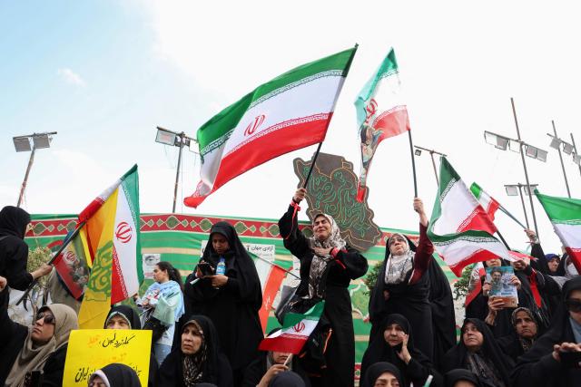 People wave Iran’s national flags during a rally to show their solidarity and support to the new Iranian supreme leader Ayatollah Mojataba Khamenei in Tehran, on April 29, 2026. US President Donald Trump on April 29 warned Iran to "better get smart soon" as efforts by Washington and Tehran to end hostilities appeared at a standstill. (Photo by AFP) / 